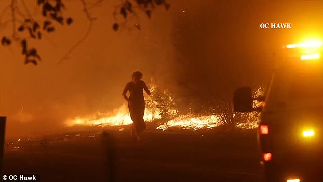 The woman was seen running through fire in California