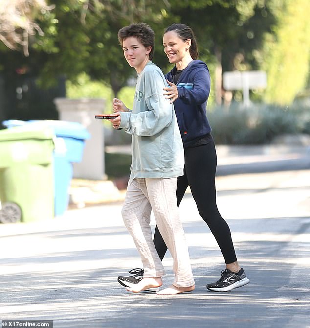 Jennifer Garner, 52, greeted her child Fin, 15, as they returned to her Brentwood home for Labor Day on Monday. Fin was surprisingly barefoot as they crossed the asphalt