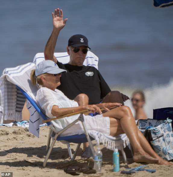 President Joe Biden and first lady Jill Biden wave as they sit on the beach in Rehoboth Beach, Delaware, Saturday, Aug. 31, 2024. (AP Photo/Manuel Balce Ceneta)