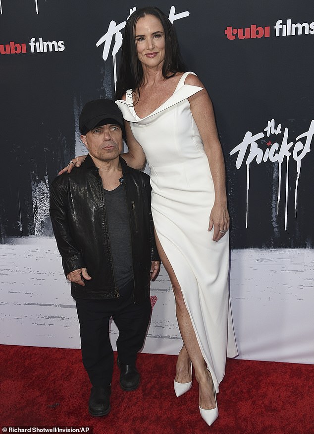 Juliette Lewis, 51, stunned in a white dress with a daring leg slit as she and Peter Dinklage, 55, attended the premiere of their film The Thicket in LA on Wednesday