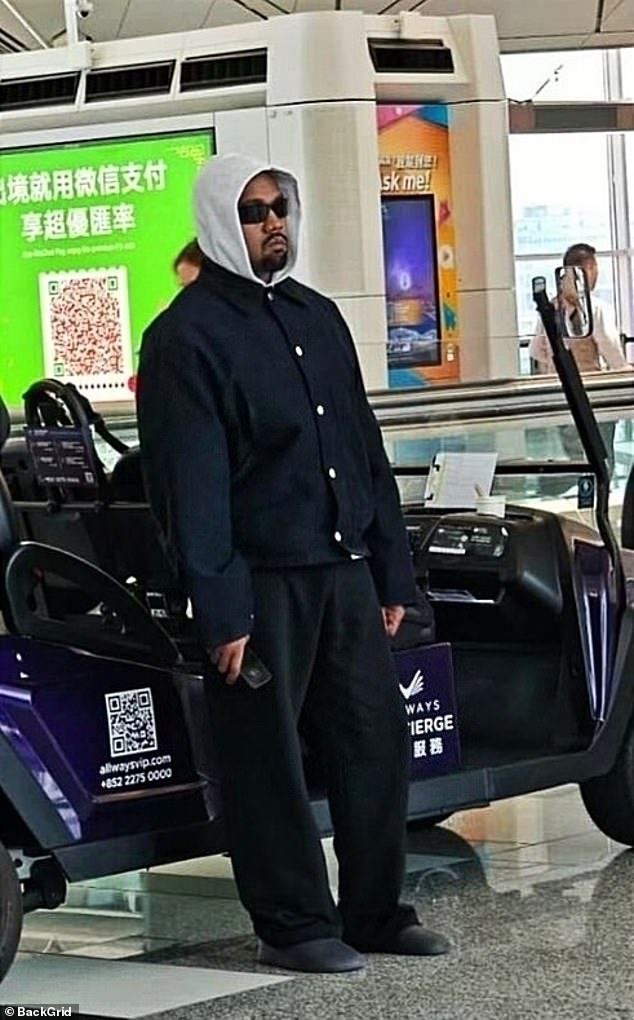 Kanye West looked down in the dumps as he arrived at Hong Kong airport alone without his wife Bianca Censori ahead of a trip to China on Friday