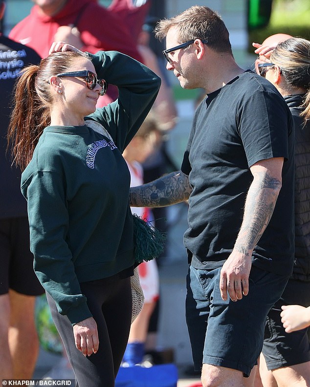 Kate Ritchie, 46, (left) had a big smile on her face on Saturday as she reunited with her ex-husband Stuart Webb, 43, (right) while they attended their daughter Mae's soccer game