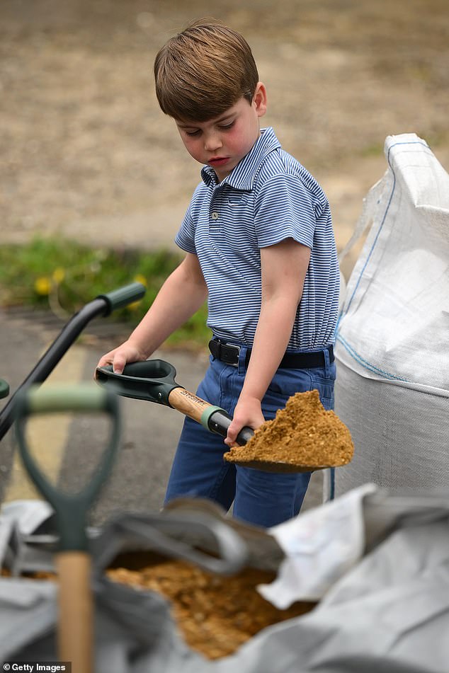 Louis shovels sand into a wheelbarrow during an engagement in Slough last year, where Kate called him 'Lou-bugs'