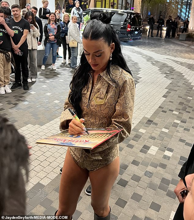 Katy Perry greeted fans as she signed autographs outside her Melbourne hotel after her headlining performance in the AFL Grand Final on Saturday