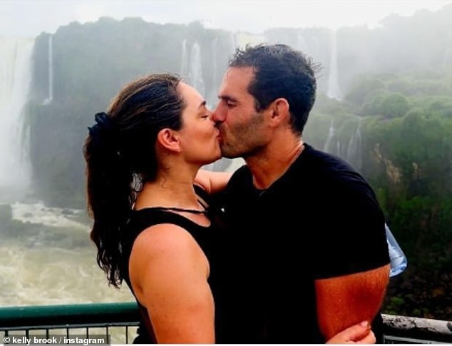 Kelly Brook put on a loving show with her husband, Jeremy Parisi, as they shared a kiss in front of the Iguazu Falls in Brazil on Thursday following the final episode of Celebrity Race Across The World