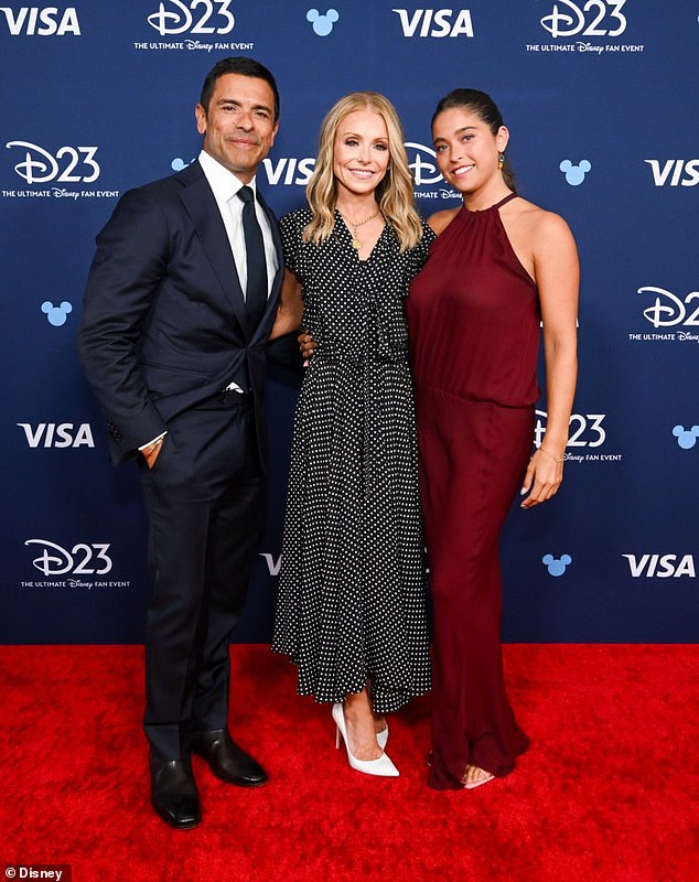 Kelly Ripa shared on Tuesday that her daughter Lola wore an old dress of hers to the Disney Legends induction ceremony in August (Kelly pictured with husband Mark Conseulos and daughter Lola at the ceremony)