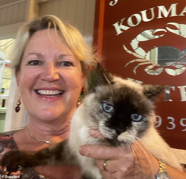 Public owner Rowena Colgrave with Precious the cat in her office at the pub on Wednesday. The cat has called the pub home for the past 14 years