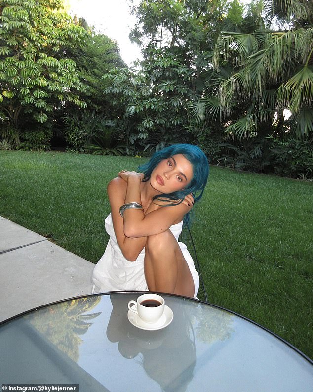 Kylie Jenner shared another photo showing off her new blue hair. The 27-year-old Kardashian star was seated at a table in her garden wearing nothing but a white towel wrapped around her famous curves