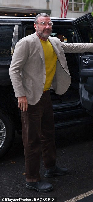 He looked charming in a woven blazer and yellow sweater paired with brown pants as he stepped out of his car