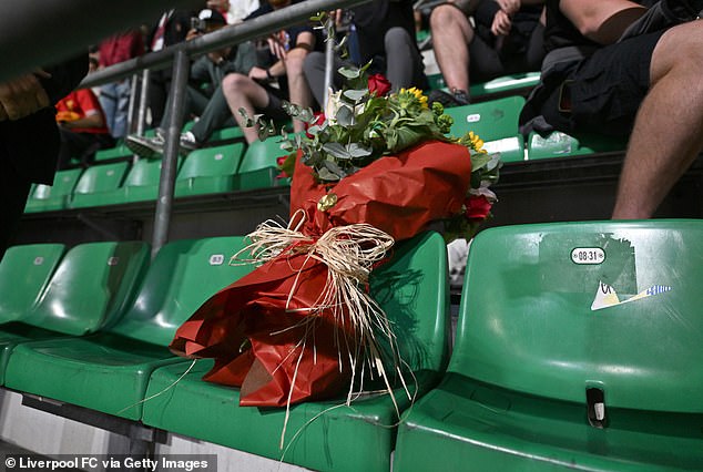 Liverpool and AC Milan executives laid flowers on the seat of Philip Dooley, 51, who died before the match in Italy