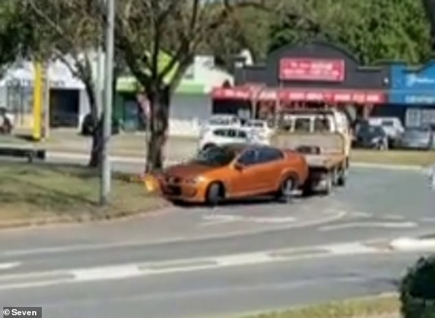 A man posing as a fake tow truck driver stole a Holden Commodore parked outside a shopping centre in Logan, south of Brisbane, on Tuesday