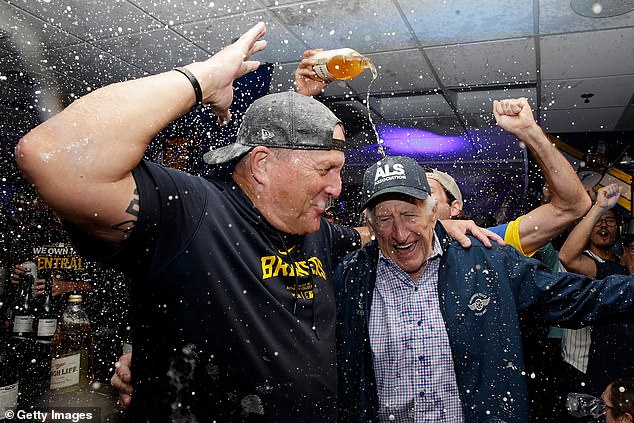 Milwaukee Brewers manager Pat Murphy #21 and Bob Uecker (right) celebrate Milwaukee winning the NL Central title