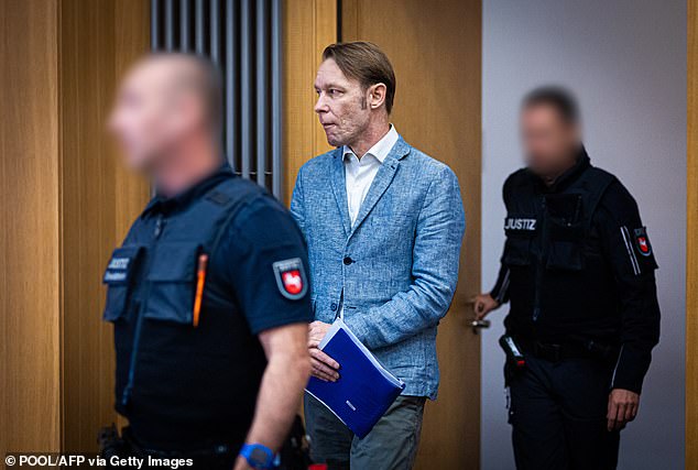 Christian Brueckner (C) is brought to the courtroom for a hearing of his trial at the court in Braunschweig, northern Germany on September 25, 2024