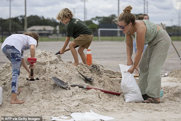 People fill sandbags in Florida in preparation for Hurricane Helene, which is expected to bring life-threatening storm surge