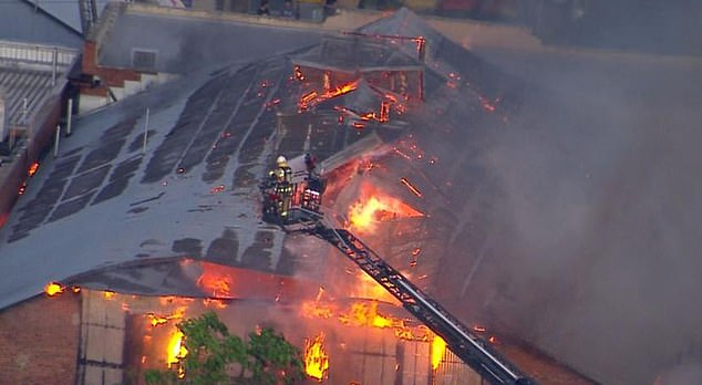 Man fighting for life as massive building blaze blankets Brisbane