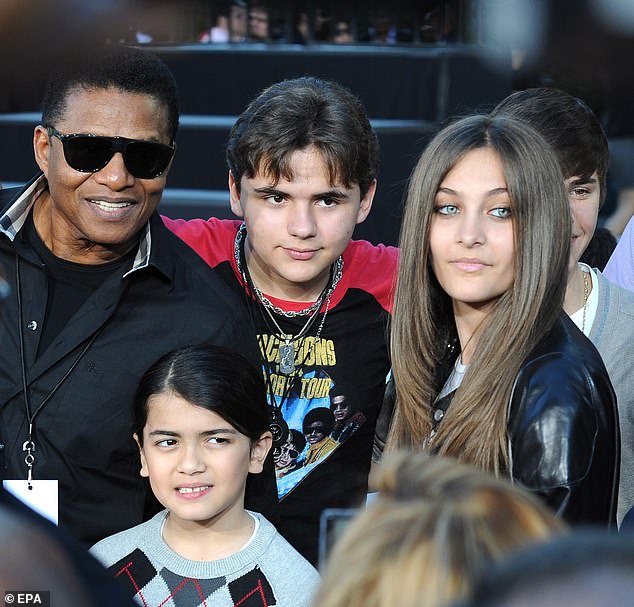 Tito Jackson pictured with his brother Michael's three children, Prince, Paris and Blanket in 2012