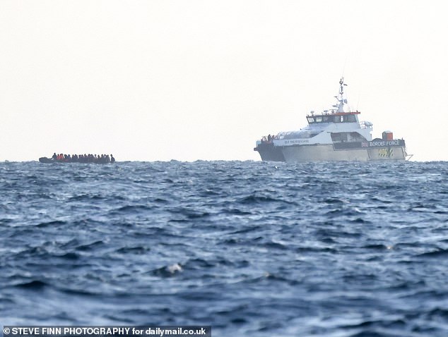 Pictured: Migrants on a small boat cross the English Channel on August 30