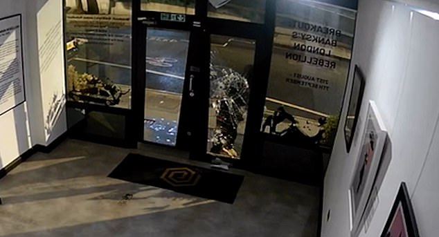 CCTV footage from inside the Grove Gallery in London shows a thief forcing his way in