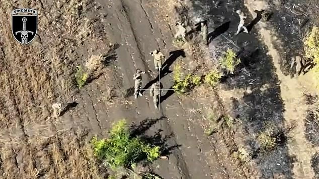 Harrowing footage shows a seven-strong attack group clearly holding their hands up as they emerge from the cover of foliage