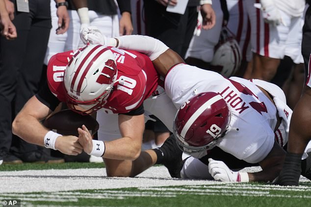 Wisconsin quarterback Tyler Van Dyke (left) was forced to leave Saturday's game after taking a hard hit