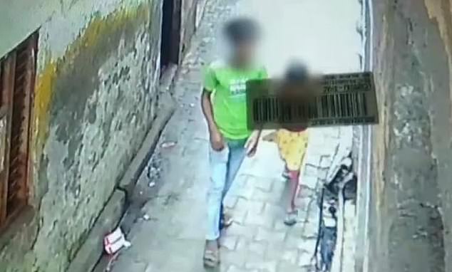 The young man (pictured above with the six-year-old girl) lured the girl to an abandoned house in Baghpat, in the northern state of Uttar Pradesh, over the weekend, Indian media reported