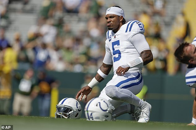 Anthony Richardson kneels during warmups before throwing three interceptions in Green Bay