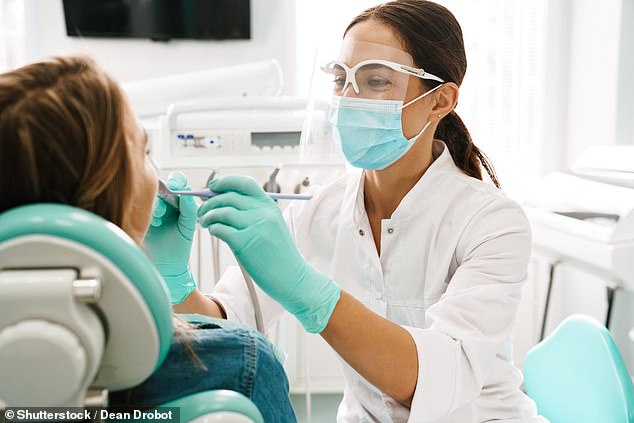 The NHS recommends that under-18s visit the dentist at least once a year, as their teeth can rot more quickly than adults. (Stock photo)