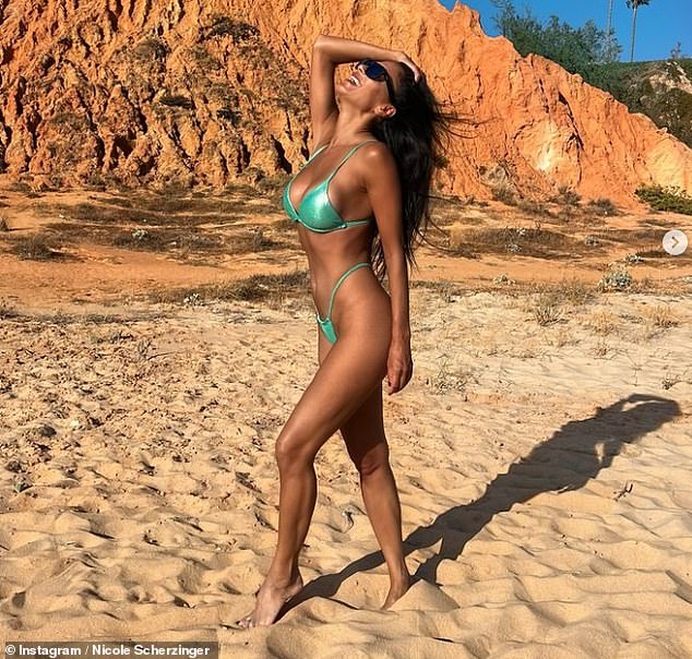 Nicole Scherzinger, 46, set pulses racing again in a revealing green thong bikini as she shared a new gallery of Instagram snaps from her lavish beach vacation on Tuesday