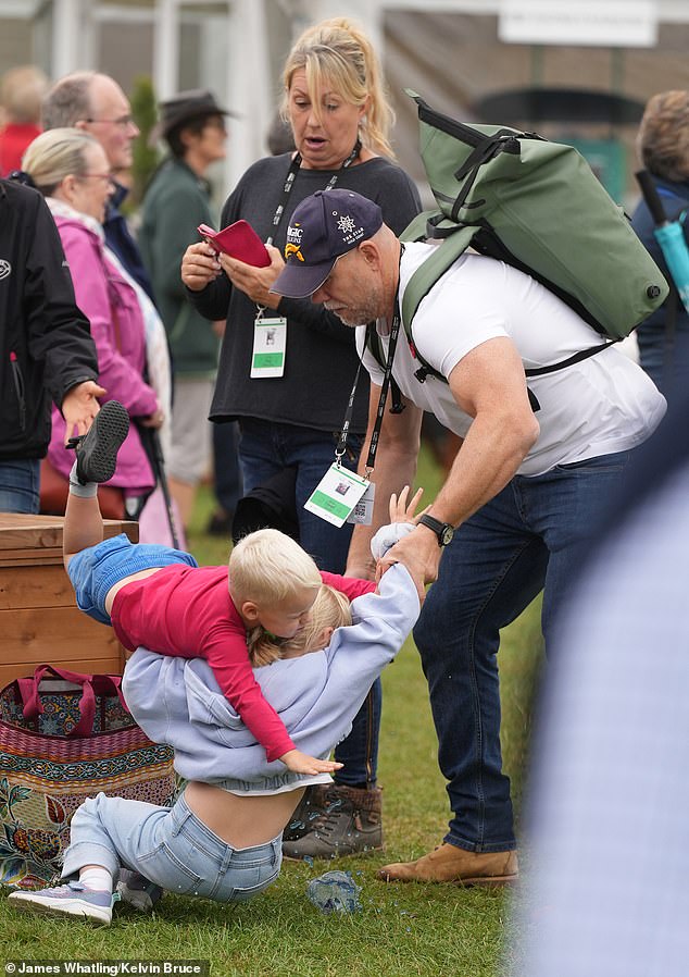 Mike Tindall was forced to break up an innocent play fight between his two youngest children as they arrived to cheer on Zara at the Burghley Horse Trials today