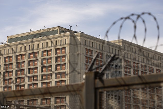 The Metropolitan Detention Center is seen through barbed wire in the Sunset Park neighborhood of Brooklyn in New York City