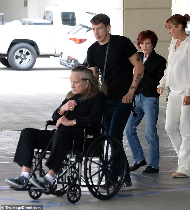 The 75-year-old rocker was pushed in a wheelchair before standing up and using a cane to walk