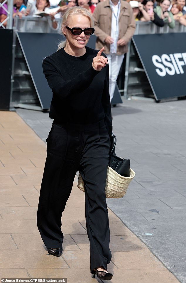 Pamela Anderson embraced the fall weather as she arrived for the 72nd San Sebastian Film Festival on Wednesday in a knitted, all-black ensemble