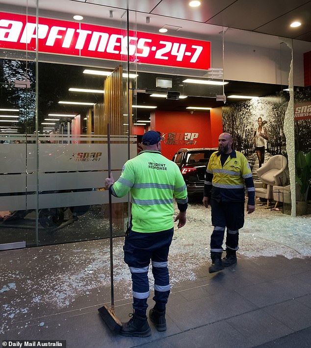 Workers in Sydney's CBD were shocked when a black SUV sped through an intersection and crashed through the window of a gym on Tuesday