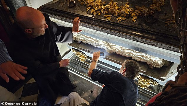 The remains of Saint Teresa were moved to a sealed space where experts can analyze her DNA and understand how to better preserve relics in the future. Pictured: The silver marble coffin of Saint Teresa of Avila