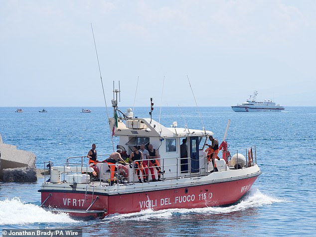 A fire brigade diving team leaves Porticello and heads to the rescue site in Sicily on August 23