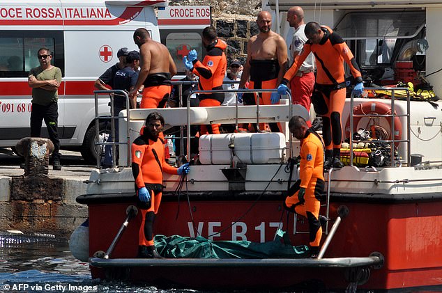 Italian fire brigade divers at Porticello on August 23 as they recover the bodies of the dead