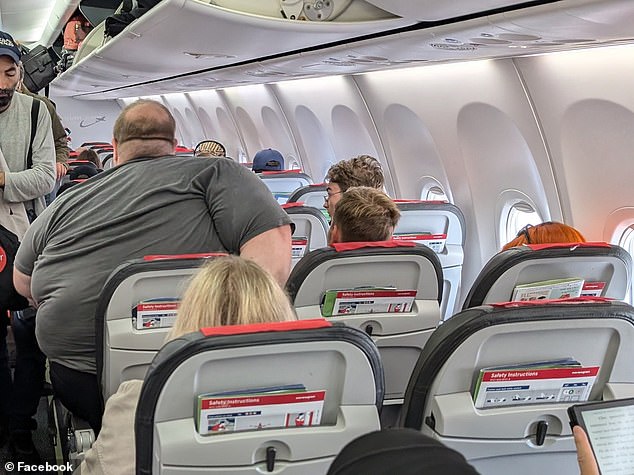 The plus-size passenger was photographed by a fellow traveler as he struggled to sit comfortably in his aisle seat on a flight from Helsinki to Copenhagen on Monday