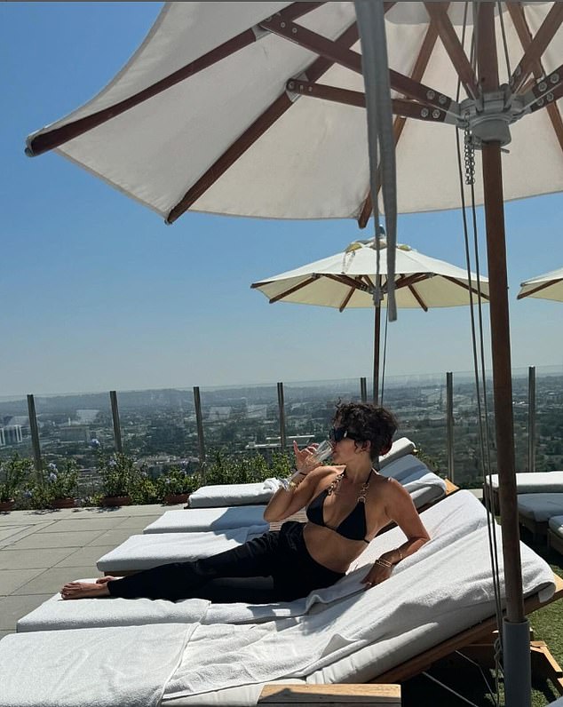 The 35-year-old shared photos of herself sipping a glass of bubbly in the sunshine by a hotel rooftop pool