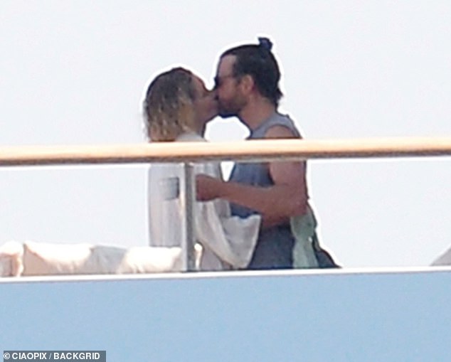 At one point, Gigi and Bradley were spotted away from the group sharing a few loving moments while cozying up together on one of the decks of the spacious yacht