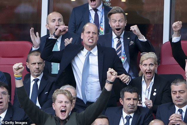 Lieutenant Commander Robert Dixon (far right) cheers with Prince William during a European Championship match earlier this year