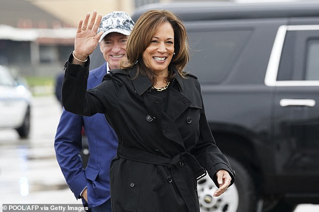 Democratic presidential candidate and Vice President Kamala Harris waves after being greeted by Sen. Mark Kelly, D-Ariz., as she departs DC for the U.S.-Mexico border