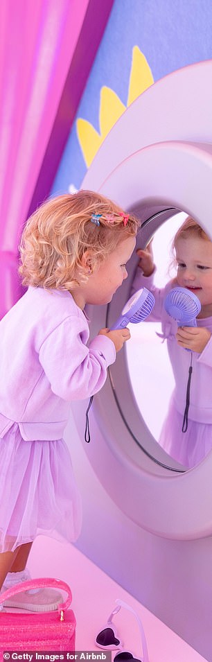 Royce pictured playing with a small hand fan