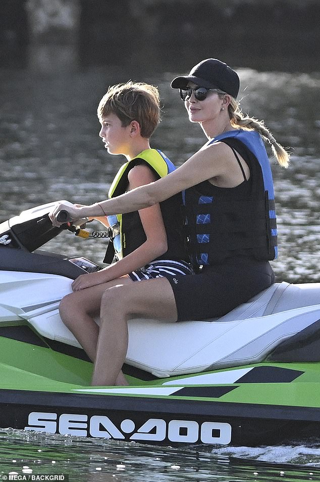 Ivanka Trump enjoyed some fun in the sun while jet skiing with one of her sons on a green and white water sports vehicle