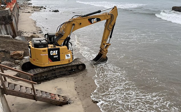 A photo from the lawsuit shows excavators dragging sand from Broad Beach