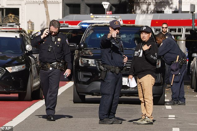 Police officers secure the area and investigate the scene of a shooting in Union Square