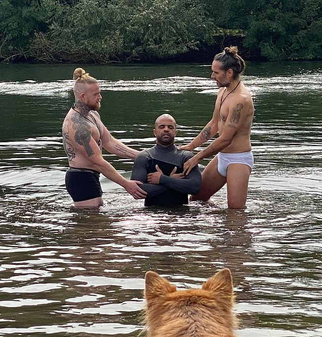 Russell Brand (right) performed a baptism this week wearing only his underwear