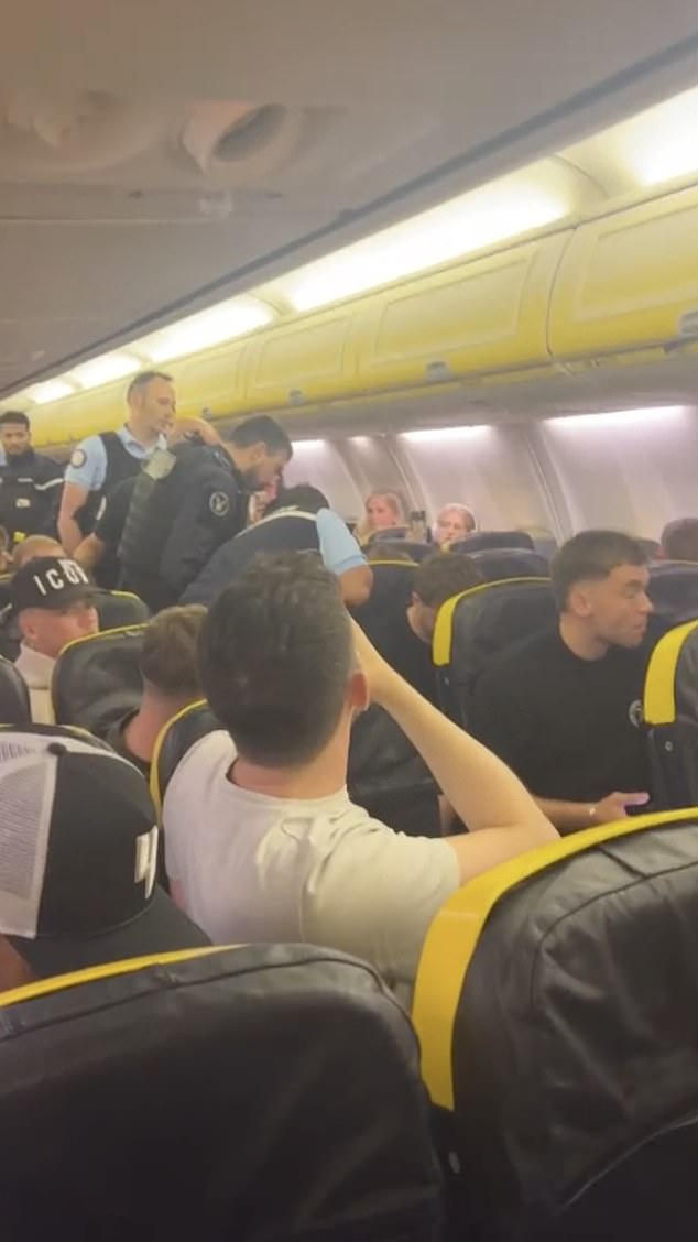 A flight was diverted after a drunken Briton drank vodka, punched the crew and spat at passengers