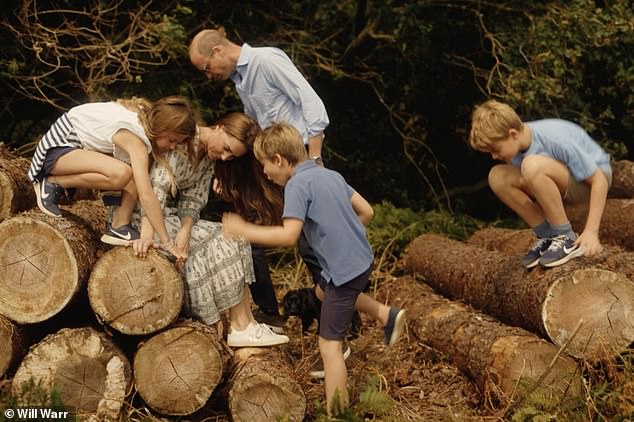 The Cambridges and their three children clamber over logs near their Norfolk home