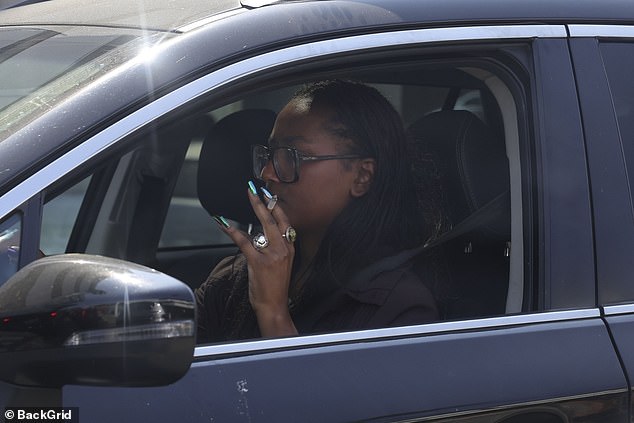 The former First Daughter puffed on a cigarette from the driver's seat of her car before driving away in Beverly Hills