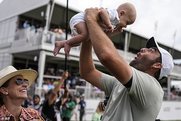 Scottie Scheffler holds his son Bennett Ezra Scheffler after winning the Tour Championship